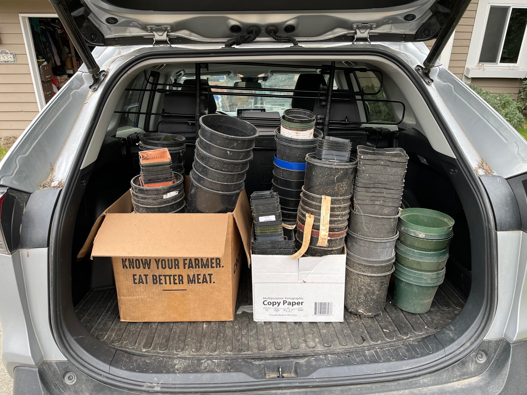 back of car filled with plastic planters