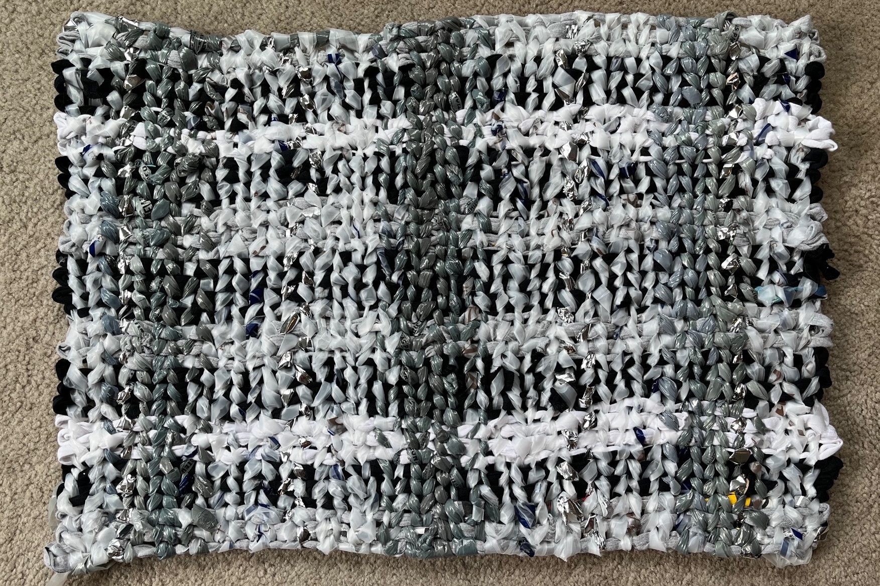 woven floor mat with black, grey and white warp, grey, white and metallic silver weft