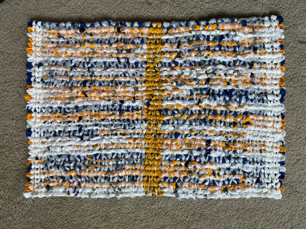 Rug in white, blue and yellow with yellow stripe in the middle