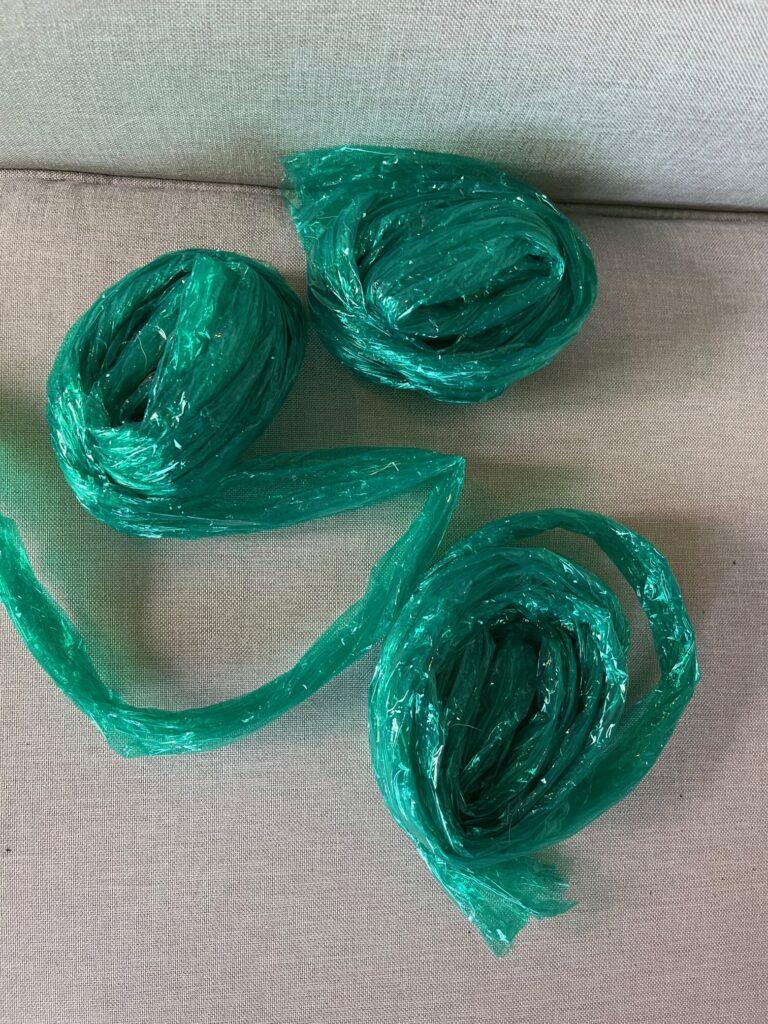 three coils of shiny green plastic