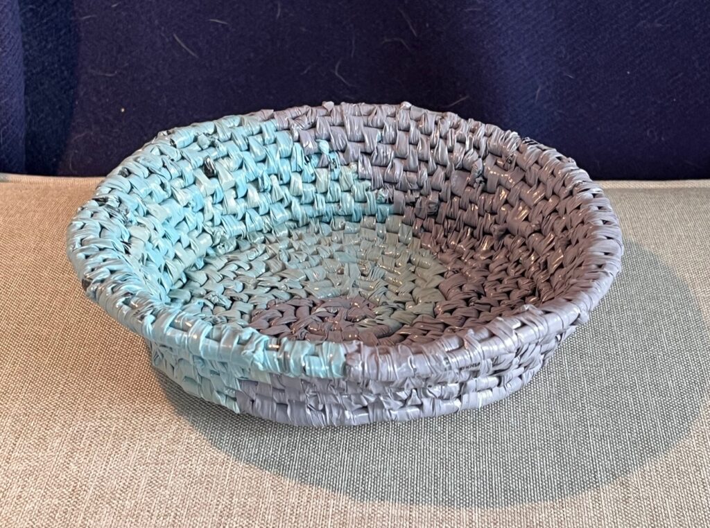 Blue and purple basket with wave design and sloped sides