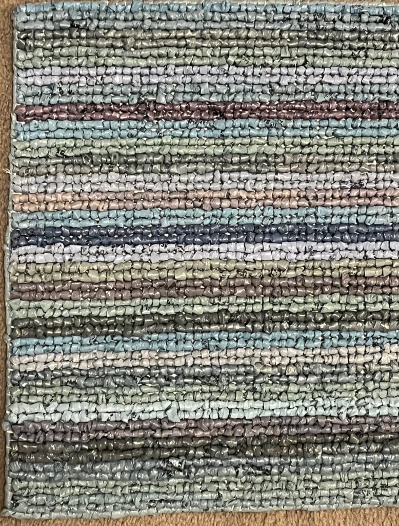 Close up of rug with multiple colored stripes