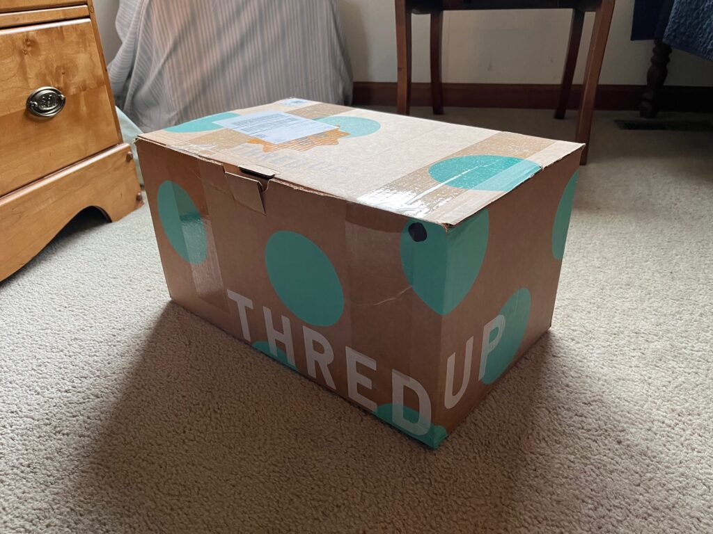 brown and teal box with white lettering "Thred Up"