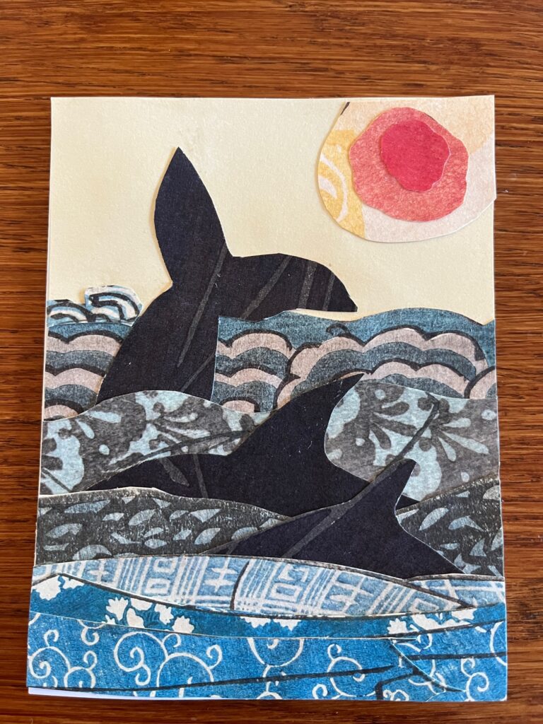 Ocean scene with three whales and sun 